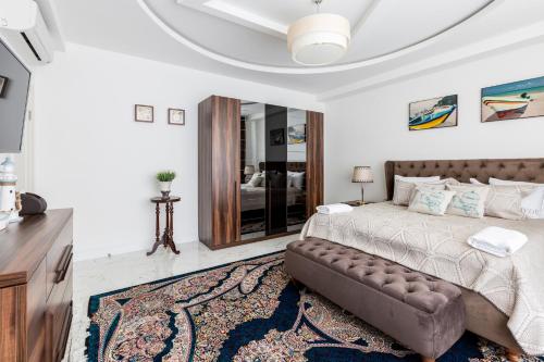 a bedroom with a bed and a couch at Villa Loreto in Shagan