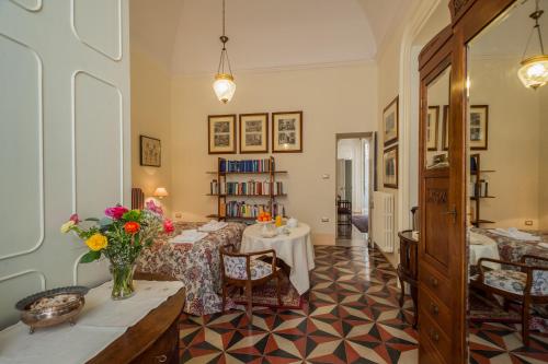a living room with a table with flowers on it at Palazzo Bernardini Suites in Lecce