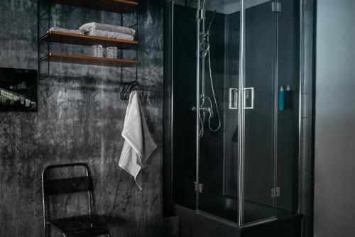 uma casa de banho com um chuveiro e uma cabina de duche em vidro. em Urbn Dreams em Berlim