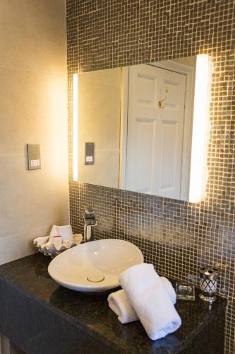 a bathroom with a sink and a mirror at Grays Court Hotel in York