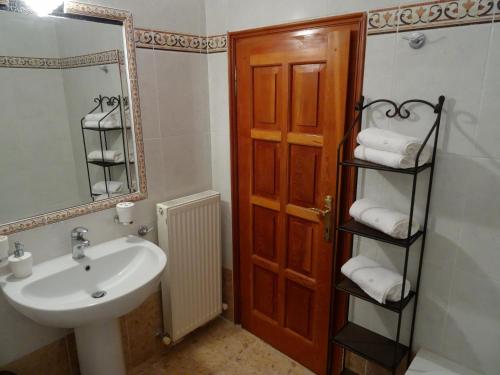 a bathroom with a sink and a mirror at Wood and Stone Villa in Sani Beach