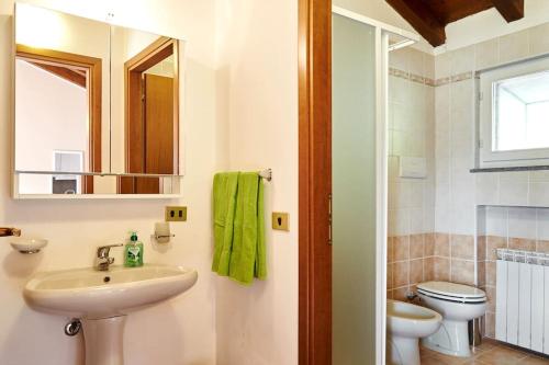 a bathroom with a sink and a toilet and a mirror at New Attic Lake View 4 in Varenna