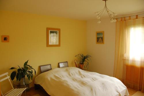 a bedroom with a white bed and a window at DaMIsa House in Metzingen