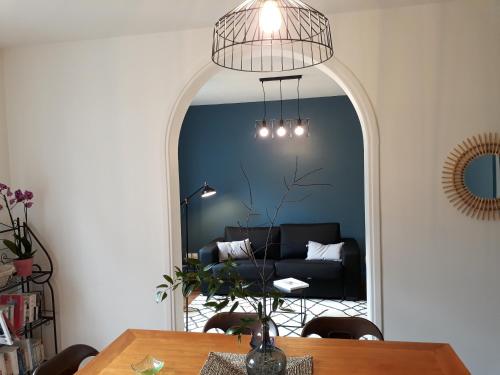 a dining room with a table and a mirror at Chalet du Doumet - Appart LUZ centre - parking et garage individuel ferme - draps et serviettes inclus in Luz-Saint-Sauveur