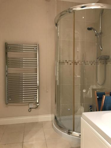 a shower in a bathroom with a glass shower stall at Achill in Bushmills