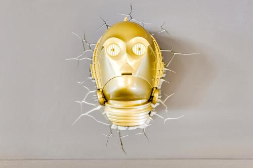 a yellow mask hanging on a wall at ibis Styles Paris Charles de Gaulle Airport in Roissy-en-France