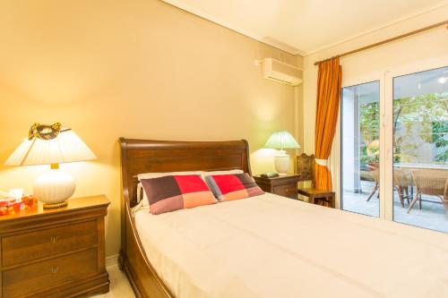 a bedroom with a bed and a sliding glass door at Villa Maya in Pallíni
