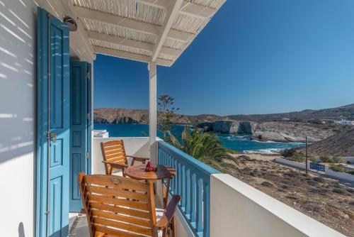 a patio with two chairs and a table on a balcony at Astraeos in Pachaina