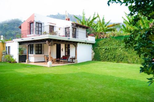 a house with a green lawn in front of it at Villas Santa Ana in Antigua Guatemala