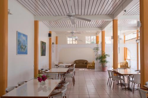 a restaurant with tables and chairs in a room at Bird Rock Beach Hotel in Basseterre