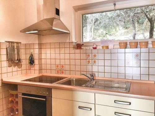 a kitchen with a sink and a window at Pandora 1 in Maccagno Inferiore