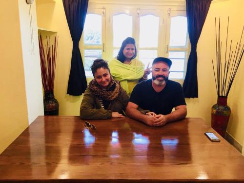 a group of three people sitting at a table at Oolala - Your lake house in the center of Udaipur in Udaipur