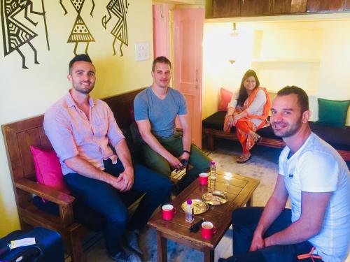 a group of people sitting in a living room at Oolala - Your lake house in the center of Udaipur in Udaipur