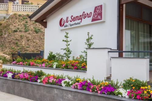 a flower garden with flowers in front of a building at Il Semaforo Sila Hotel in Taverna