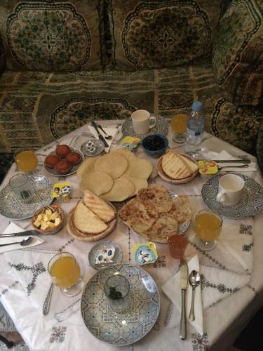 a table topped with plates of food and drinks at Riad Scalia Traditional Guesthouse Fes Morocco in Fès