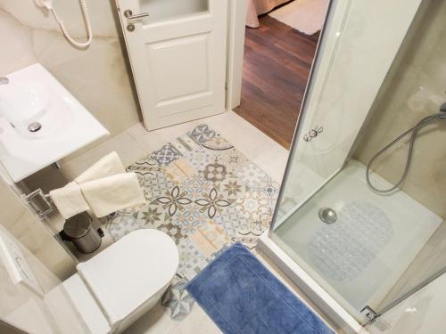 a small bathroom with a shower and a toilet at DeVecchi rooms in Hvar
