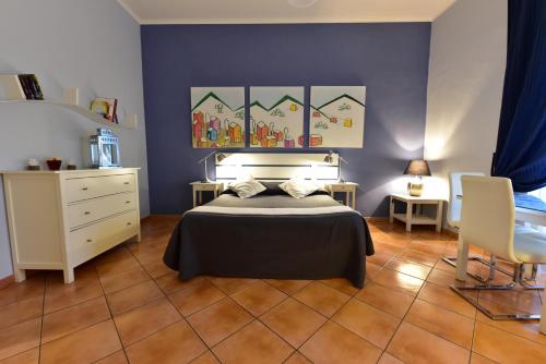a bedroom with a bed and a blue wall at QuodLibet in Rome