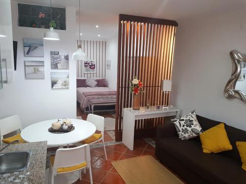 a living room with a couch and a table at Apartamento Sado II in Setúbal