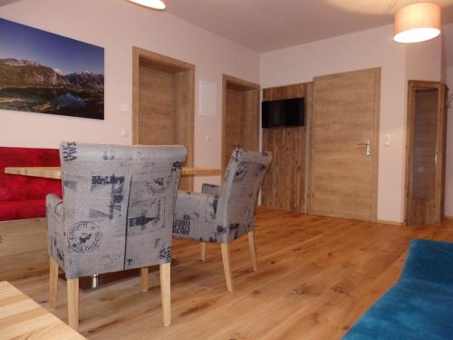 a living room with two chairs and a table at Sportlerhof - Alimann UaB in Grünau im Almtal