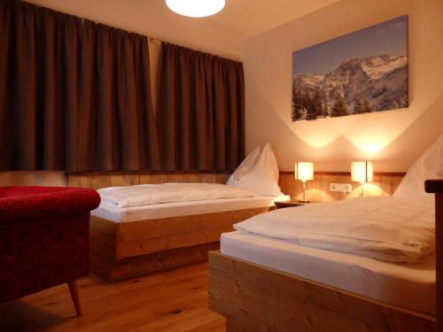 A bed or beds in a room at Sportlerhof - Alimann UaB