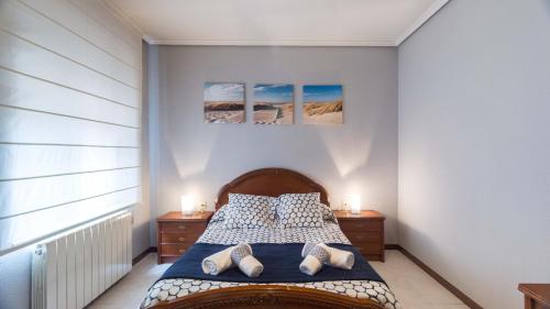 a bedroom with a bed with two dressers and two lamps at San Andres in Zamora