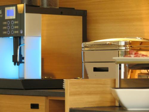 a kitchen with a counter top with a food appliance at Hotel Neuthor in Ulm