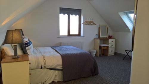 a bedroom with a bed and a window at Doolin Heights Apartment in Doolin