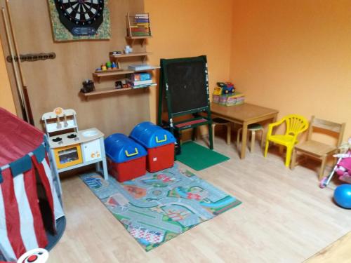 a toy room with a table and a chalkboard at Villa Holiday in Karlovy Vary