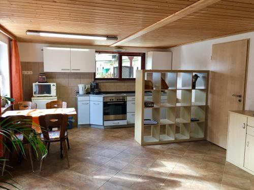 a kitchen and dining room with a table and a table and chairs at Ferienwohnung Am Grünbach 1 in Kurort Rathen