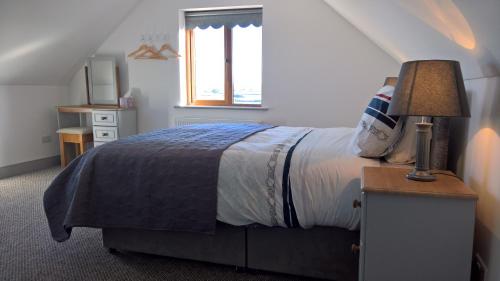 a bedroom with a bed and a window at Doolin Heights Apartment in Doolin