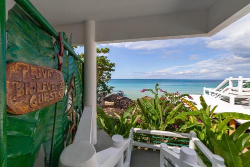 a view of the ocean from the balcony of a house at Beach House Condos, Negril in Negril
