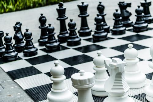 a chess board with black and white chess pieces at Riande Aeropuerto Hotel Casino in Tocumen