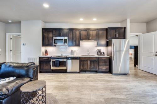 a kitchen with wooden cabinets and a stainless steel refrigerator at Watchman Villas in Springdale