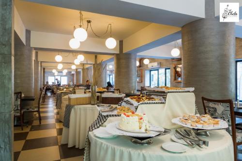 a dining room with tables with food on them at Hotel Panamericano in Santiago