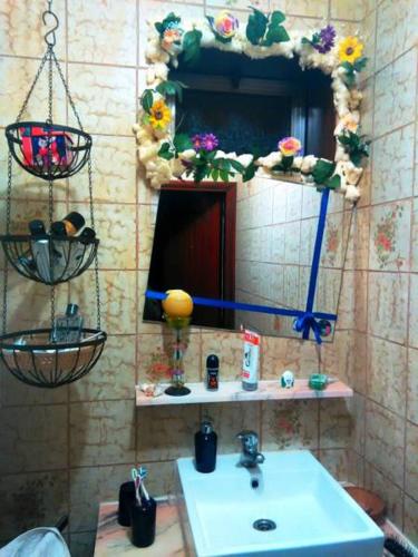 a bathroom with a sink and a mirror at Coffee Cream Guest House Maia in Maia