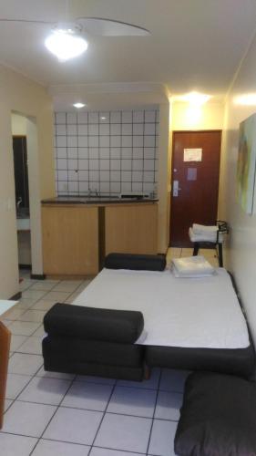 a bedroom with a large bed in a room at Apart Hotel Quartier Latin in Vitória