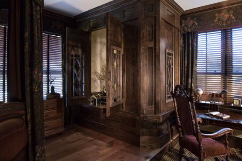 a room with wooden walls and a desk and a chair at The Chanler at Cliff Walk in Newport