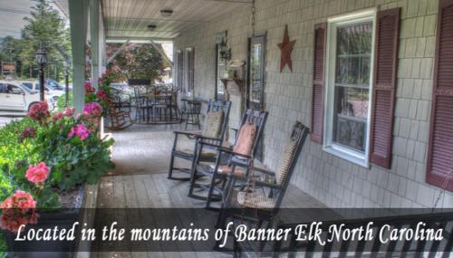 a screened in porch of a house with chairs and flowers at Little Main Street Inn in Banner Elk