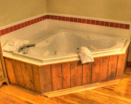 a bath tub with towels on the side of it at Little Main Street Inn in Banner Elk