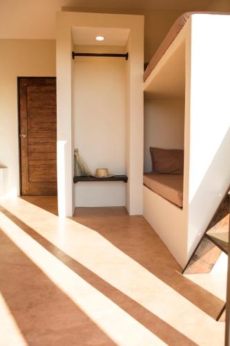a small bedroom with a bed and a staircase at Casa Mono in San Agustinillo