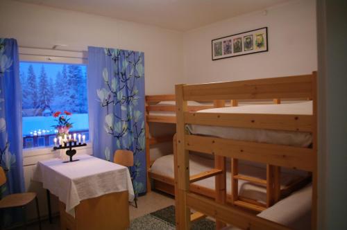 a room with two bunk beds and a table at Aneen Loma Vacation and Cottages in Posio