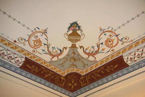 a ceiling in a room with a painting on it at Aretusa Vacanze B&B in Siracusa