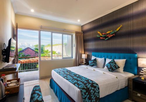 a bedroom with a large bed and a large window at Destiny Villas and Residence in Seminyak