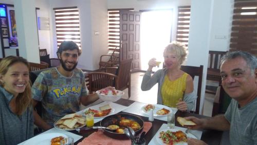 a group of people sitting around a table eating food at Bamboo Creak in Thekkady