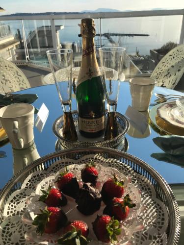 a bottle of champagne and strawberries on a table at Donna's Bed & Breakfast in White Rock