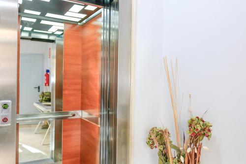 a glass door in a room with a mirror at BET Apartments - Tramontana Apartments in Valencia