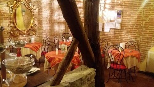 a dining room with tables and chairs and a mirror at Antica Corte dei Principi Charming Rooms in Lucca