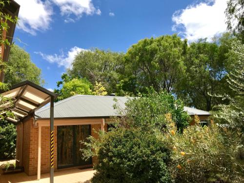 a brick house with a metal roof at Little Shangri-La in Busselton