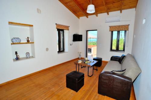 a living room with a couch and a table at Pithari Villa in Agios Dimitrios