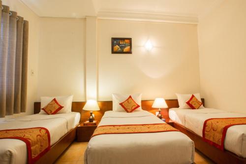 Postel nebo postele na pokoji v ubytování Ngoc Minh Hotel